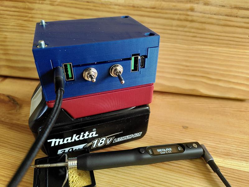 A blue 3d printer cuboid shape. Attached to a red part which is in turn
attached to a black Makita 18v battery. On the front there are four USB
connectors, two type c, two type a, plus a pair of switches. A black usb-c
cable is plugged into the left most port and leads to a soldering iron
laying in front. The screen on the soldering iron shows "Sequre ver 1.11".
The tip of the soldering iron rests on a metal
stand.
